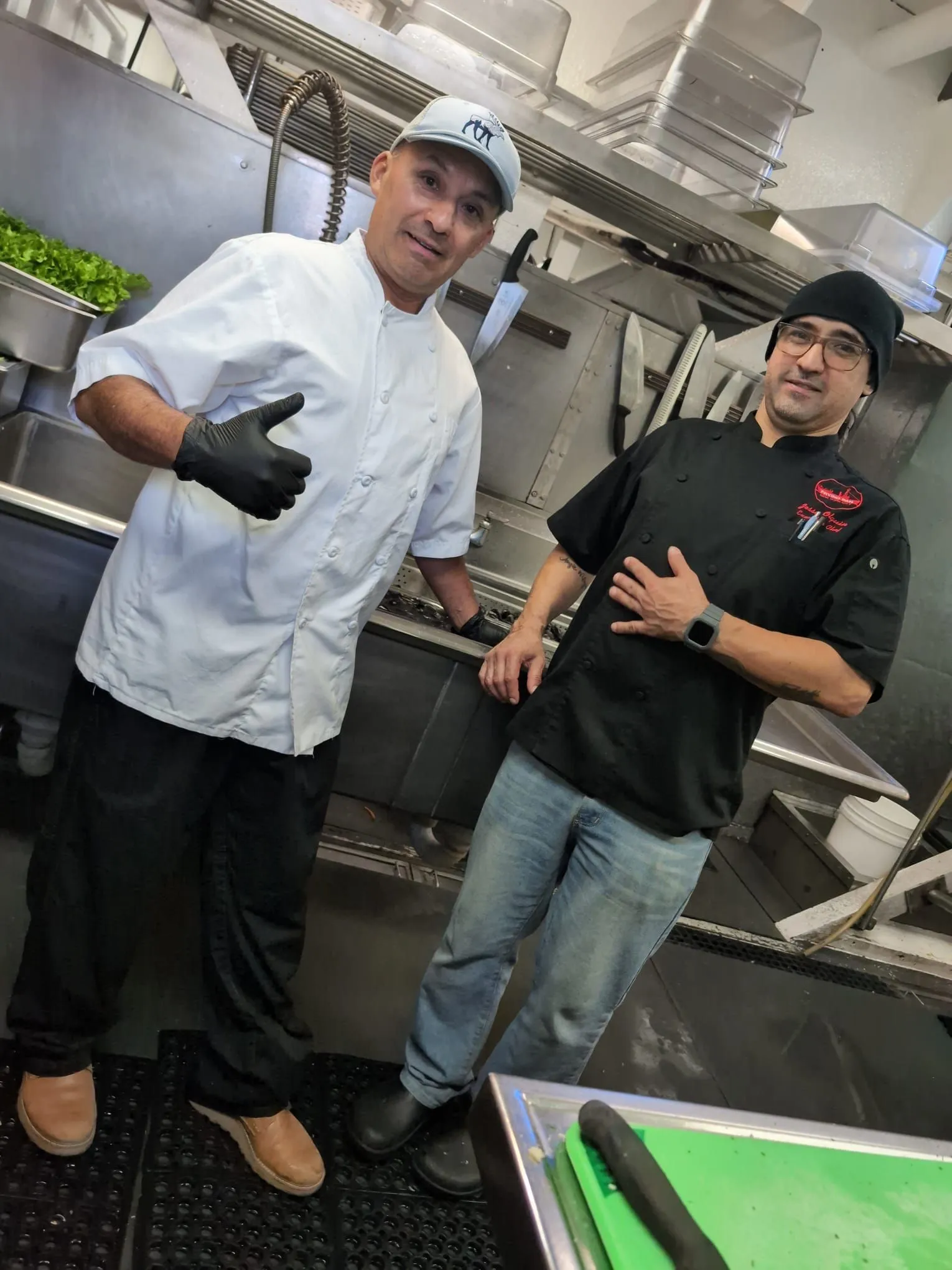 Chef Jesse and a colleague working together on the kitchen line